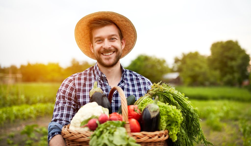 happy farmer with basket of vegetables